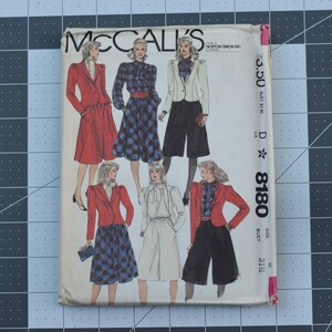 May include: A vintage McCall's sewing pattern envelope featuring five different outfit designs. The pattern number is 8180 and the size is 31 1/2 bust. The envelope is white with a pink border and features a black and white star.