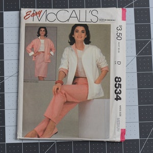 May include: A sewing pattern for a white jacket and pink trousers. The pattern number is 8534 and the size is medium. The pattern is from McCall's Easy.