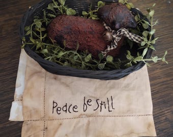 Blackened Wax Sheep in Basket Set on Hand Embroidered Linen Table Mat