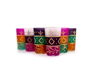 May include: Set of six colorful glass tumblers with gold painted designs. The glasses are frosted and have a variety of patterns, including geometric shapes and floral motifs.
