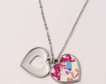 May include: A silver necklace with two heart-shaped pendants. The larger pendant features a colourful illustration of a couple and the text "My Love". The smaller pendant is open and has a heart-shaped cutout.