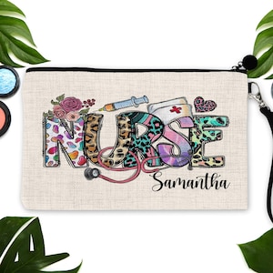 May include: A beige canvas makeup bag with a colourful "NURSE" design featuring a stethoscope, a syringe, and a heart. The bag has a black zipper and a black strap. The name "Samantha" is printed below the design.