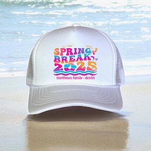 May include: White trucker hat with a colorful "Spring Break 2025" graphic, palm trees, sunglasses, and the text "matthews family - destin".