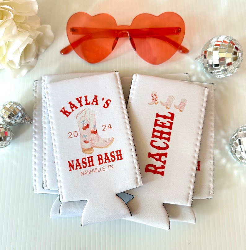 May include: White foam can coolers with red text and a design of cowboy boots. The text reads "Kayla's 20 24 Nash Bash Nashville, TN" and "Rachel".