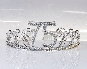 May include: Silver tiara with rhinestones, featuring the number 75. The tiara is designed for a birthday celebration.