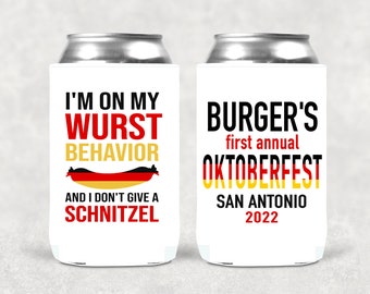 May include: Two white can coolers with black, red, and yellow text. One says "I'M ON MY WURST BEHAVIOR" with a sausage graphic and "AND I DON'T GIVE A SCHNITZEL." The other says "BURGER'S first annual OKTOBERFEST SAN ANTONIO 2022."