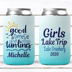 May include: Two blue and white can coolers with text. The first cooler says "good times and tan lines" with a sun and birds. The second cooler says "Girls Lake Trip Lake Granbury 2020".
