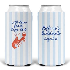 May include: Two white and light blue striped foam can coolers. The left cooler features a red lobster holding a wine glass with the text "with love from Cape Cod" in blue. The right cooler displays the blue text "Stephanie's Bachelorette August '26".