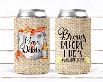 May include: Two burlap can coolers with a wedding theme. One cooler features a drawing of a pot of crawfish with the text "Clare & Dakota". The other cooler has the text "Brews Before I Do's #WannaMakeAway" with lemons.