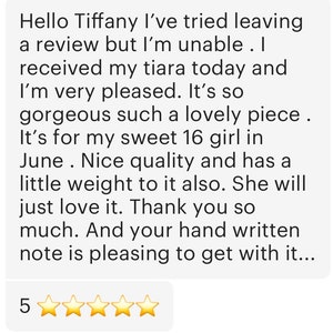 May include: A customer review with text praising a tiara, mentioning its quality and appeal. The review is accompanied by a five-star rating, indicating high satisfaction with the product.