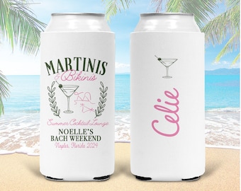 May include: Two white can coolers with a martini glass design. One cooler says "Martini's & Bikinis Summer Cocktail Lounge Noelle's Bach Weekend Naples, Florida 2024". The other cooler says "Celie" in pink.