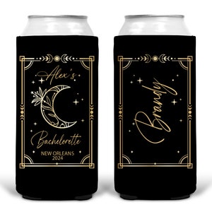 May include: Two black and gold can coolers with a moon and stars design. One cooler says "Alex's Bachelorette New Orleans 2024" and the other says "Brandy".