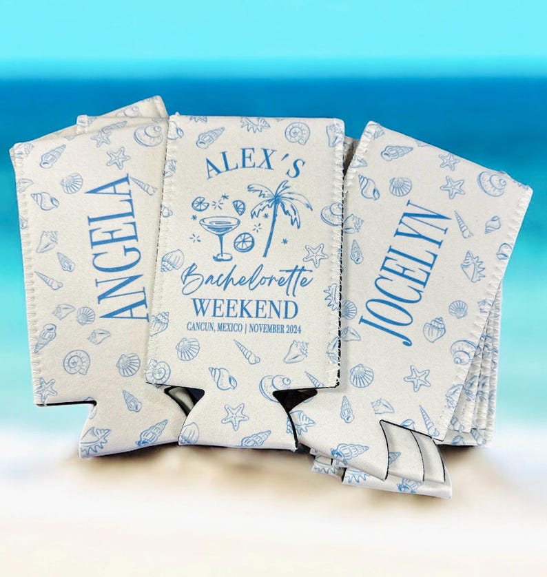 May include: Three white foam can coolers featuring a blue seashell pattern. The center cooler displays the text "ALEX'S BACHELORETTE WEEKEND CANCUN, MEXICO | NOVEMBER 2024" with a martini glass and palm tree icon. The side coolers are personalized with "ANGELA" and "JOCELYN".