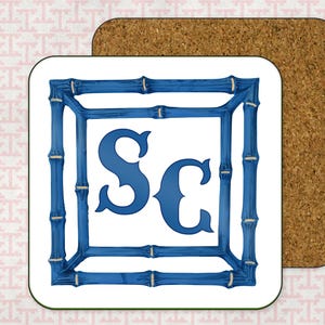 May include: White coaster with a blue bamboo frame and the letters "SC" in blue inside the frame.