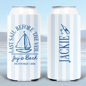 May include: Two slim can coolers featuring a light blue and white vertical striped pattern. The left cooler displays a sailboat graphic with the text "LAST SAIL BEFORE THE VEIL", "Juj's Bach", and "HILTON HEAD | 2026". The right cooler says "JACKIE".