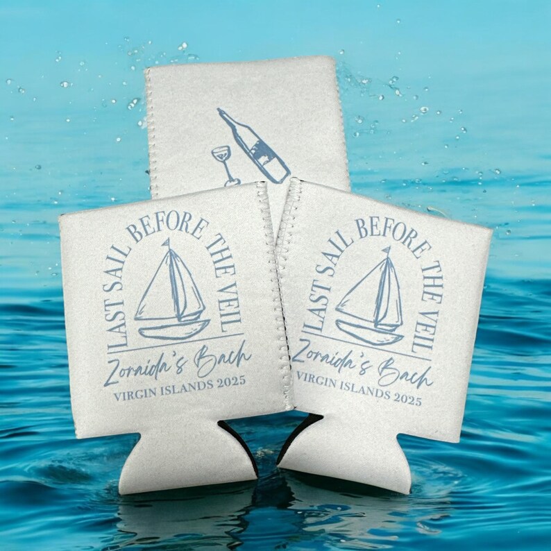 May include: Three white foam can coolers featuring a blue graphic of a sailboat and a wine bottle. The text reads Last Sail Before The Veil, Zornida's Bach, and Virgin Islands 2025. The design is printed in a blue ink on the front of each cooler.