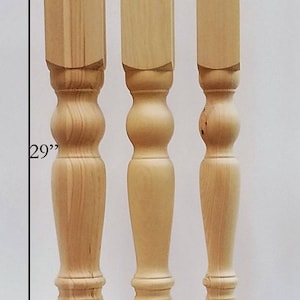 May include: Three wooden table legs with a turned design. The legs are 29 inches tall and have square tops measuring 4 inches, 3.5 inches, and 3 inches wide.