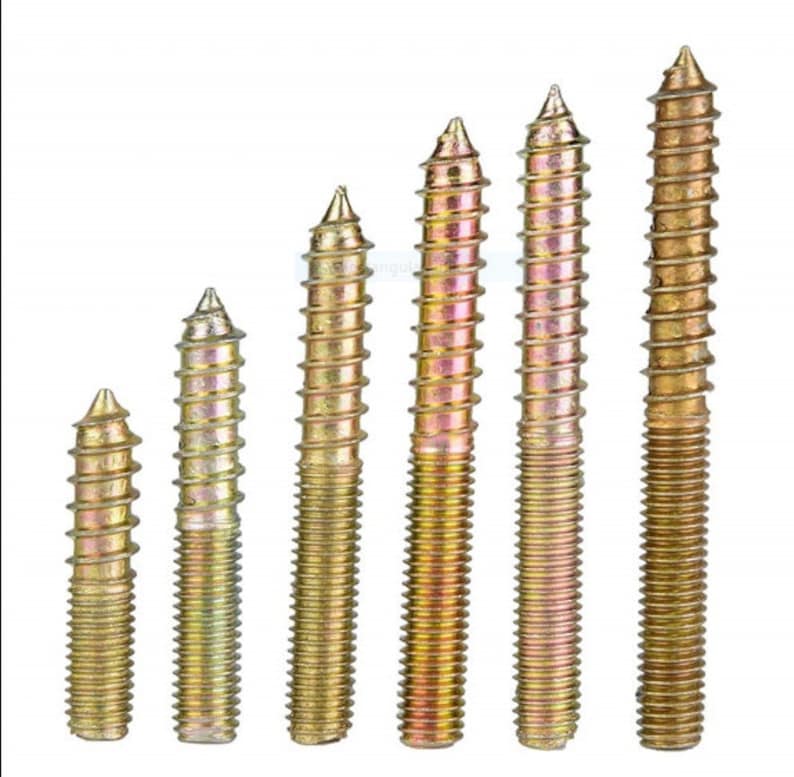 May include: A set of six gold-toned metal screws with pointed tips and a threaded design. The screws are arranged in order of size, with the smallest screw on the left and the largest screw on the right.