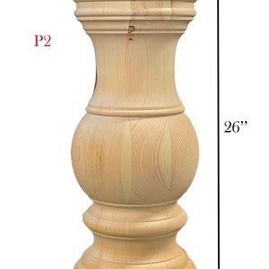 May include: A natural wood table leg with a turned design. The leg is 26 inches tall and 10 inches wide. P2.