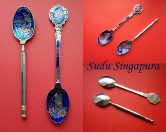 Singaporean Stylish Two Enamel Spoons- Designs of Merlion and ‘Singapore Orchid Papilionanthe Miss Joaquim’- Collectible Dining Ware