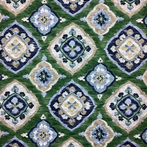 May include: Green fabric with a repeating pattern of blue, white, and beige diamond shapes. The pattern is intricate and features floral motifs.