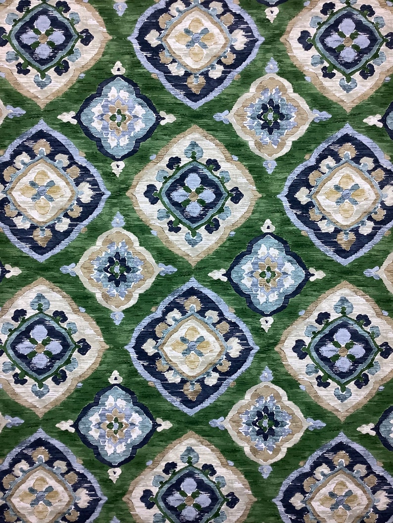 May include: Green fabric with a repeating pattern of blue, white, and beige diamond shapes. The pattern is intricate and features floral motifs.