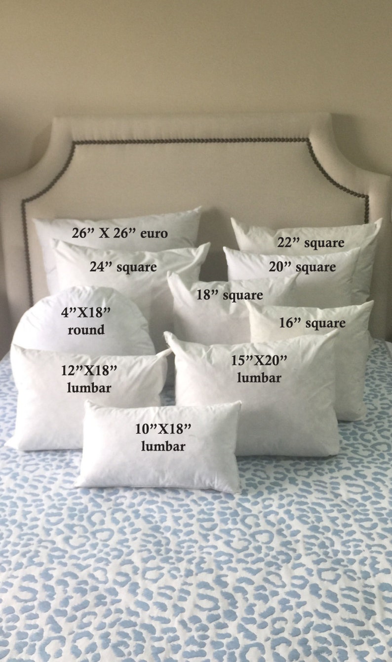 May include: A variety of white pillow inserts in different sizes and shapes, including square, round, and lumbar. The pillows are arranged on a blue and white patterned bedspread.