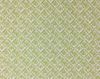 May include: Green and white fabric with a repeating diamond pattern. The fabric has a subtle texture.