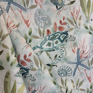 May include: A watercolor fabric design featuring a light blue background with a variety of sea life, including sea turtles, starfish, seashells, and coral. The design is perfect for creating a coastal or nautical themed home decor project.