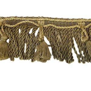 May include: Gold braided trim with tassels. The trim has a woven texture and is approximately 1 inch wide.