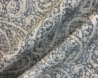May include: A close-up of a fabric with a gray and white damask pattern. The fabric has a textured, linen-like appearance.