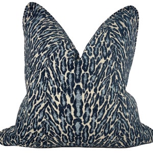 May include: A blue and white leopard print cushion with a soft, textured fabric.