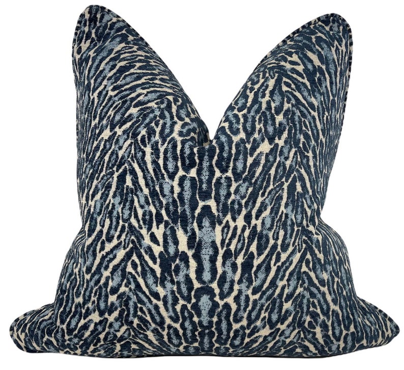 May include: A blue and white leopard print cushion with a soft, textured fabric.
