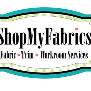 May include: A teal blue and black sign with a green and white diamond pattern. The sign says "ShopMyFabrics" in black text and "Fabric &bull; Trim &bull; Workroom Services" in smaller black text.