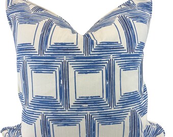 May include: A white pillow with a blue geometric pattern. The pattern is made up of squares and lines.