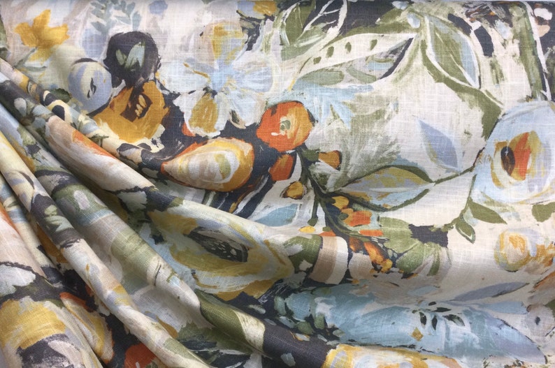 Pode incluir: Um tecido com um padr&atilde;o floral em tons de azul, verde, amarelo e laranja. O tecido tem uma textura de linho e &eacute; perfeito para estofamento ou cortinas.