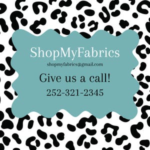 Pode incluir: Uma placa turquesa com borda ondulada com o texto "ShopMyFabrics" e informa&ccedil;&otilde;es de contato, em um fundo de estampa animal em preto e branco. A placa tamb&eacute;m inclui a frase "Give us a call!" e um n&uacute;mero de telefone.