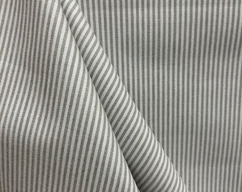 May include: White fabric with thin gray stripes. The fabric is folded and shows the pattern from different angles.