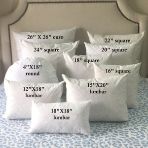 May include: A variety of white pillow inserts in different sizes and shapes, including euro, square, and lumbar. The pillows are arranged on a white bed with a blue and white leopard print pattern.