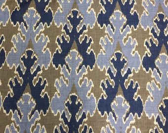 May include: A fabric with a repeating pattern of blue, brown, and white abstract shapes. The shapes resemble stylized leaves or flowers.