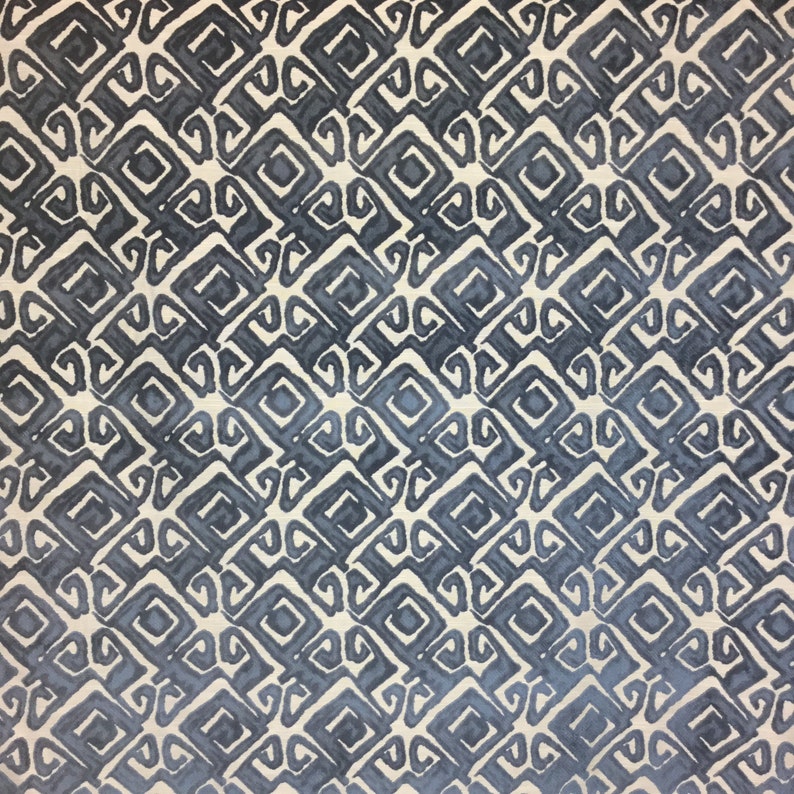 May include: A repeating pattern of dark blue and off-white geometric shapes. The design features a series of interconnected squares and stylized scroll-like elements, creating a textured, all-over print. The pattern has a watercolor-like effect.