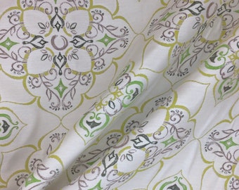May include: White fabric with a repeating pattern of green, gray, and yellow floral designs. The fabric has a subtle texture.
