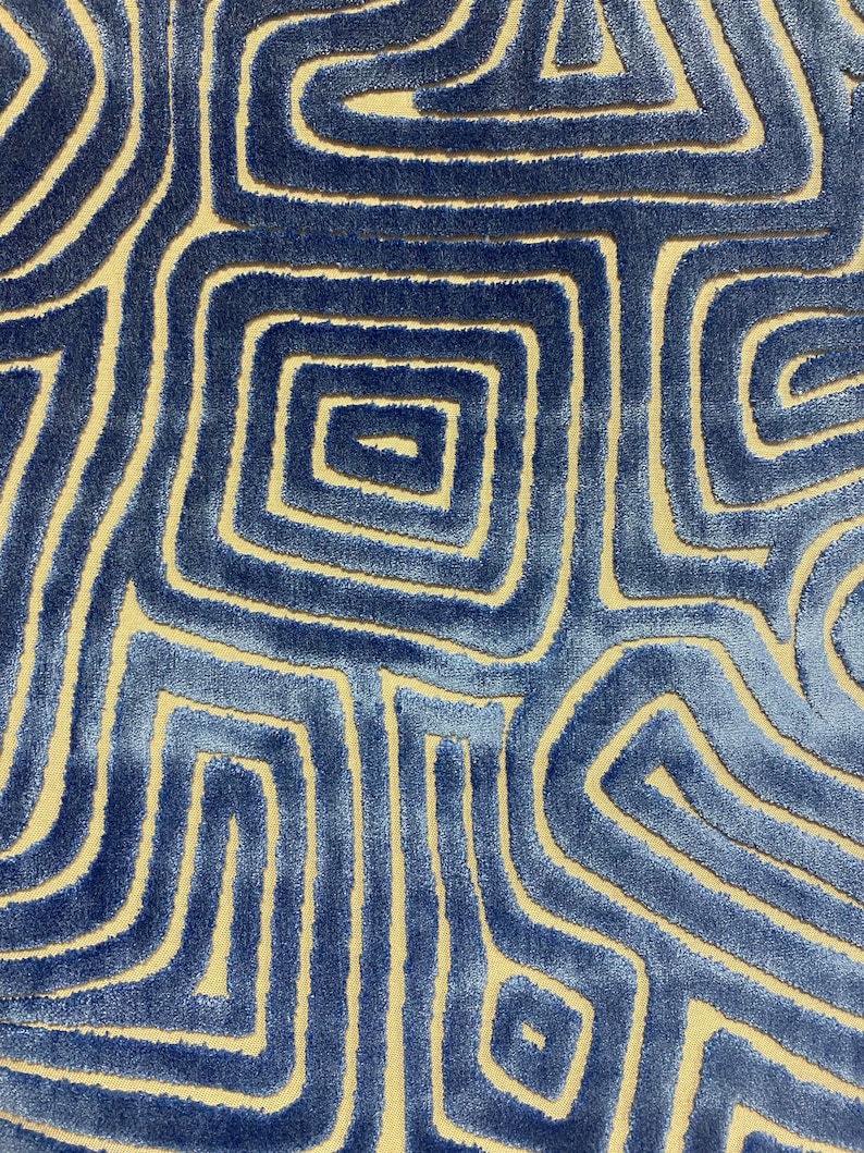 May include: Blue and beige patterned fabric with a geometric design. The fabric has a raised texture, creating a 3D effect.