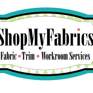 May include: A teal blue and black sign with a white background and the text "ShopMyFabrics" in black. The text "Fabric &bull; Trim &bull; Workroom Services" is also in black below the main text.
