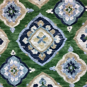 May include: Green, blue, and beige patterned fabric with a repeating geometric design. The fabric has a textured, woven look.