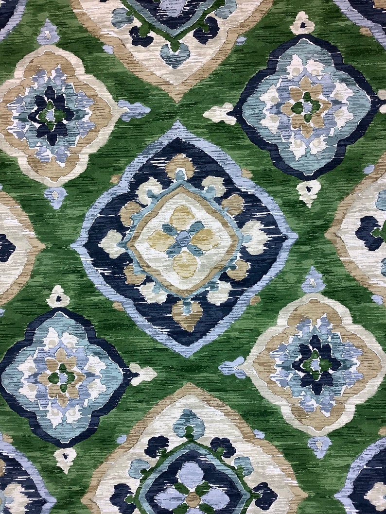 May include: Green, blue, and beige patterned fabric with a repeating geometric design. The fabric has a textured, woven look.