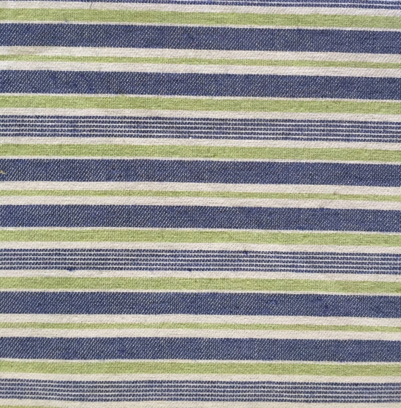 May include: A close-up of a striped fabric with alternating bands of green, white, and blue.