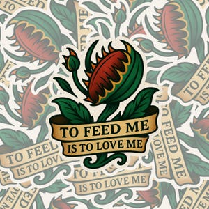 May include: A sticker featuring a stylized Venus flytrap with a red and green flower. The design includes a banner with the text "TO FEED ME IS TO LOVE ME" in a vintage tattoo style. The background is filled with similar designs.