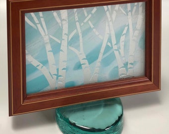 Moments in Time, framed, freestanding multi-colored glass etching of birch trees set on a cast glass base.