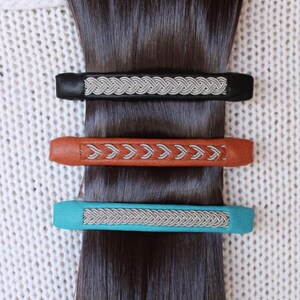 Three hair clips on a dark brown hair.
Handmade in genuine reindeer leather, Black, Nature Brown and Aqua. AC Design
3 Hair barrettes
The perfect gift for her or mum!